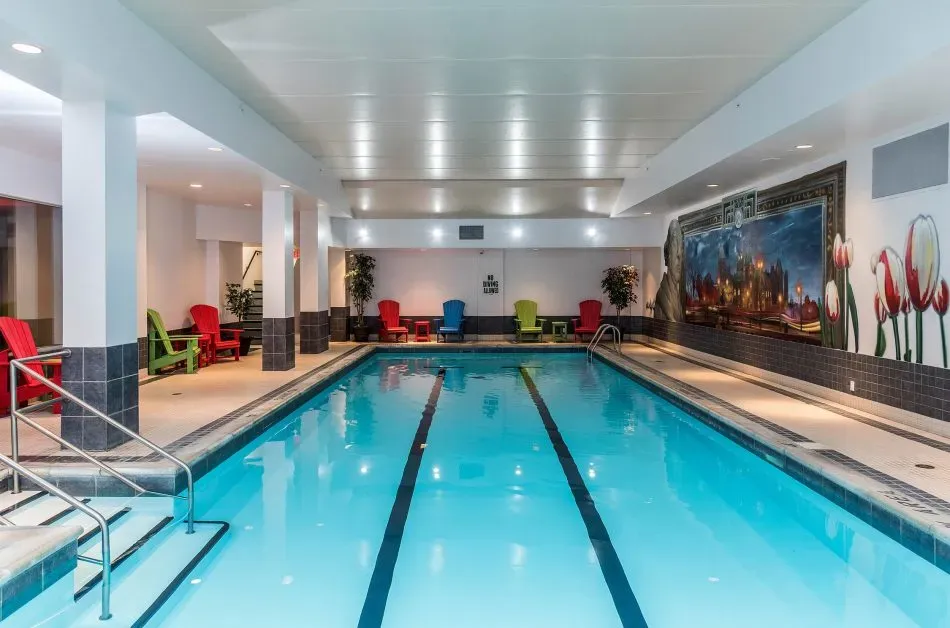 A shot of our Ottawa hotel pool, with colourful deck chairs and custom art of Parliament and our city's famed Tulips painted on the wall.